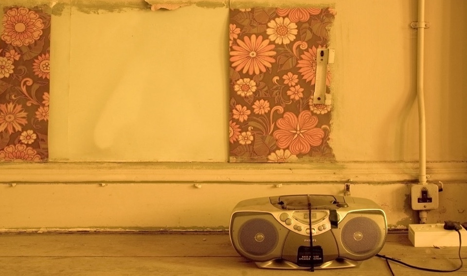 A wall socket in a bare room with a multi-way extension block plugged into it