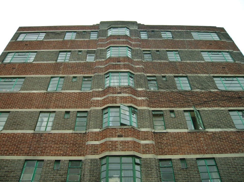 A 1930s brick block of flats in south London seen from the pavement